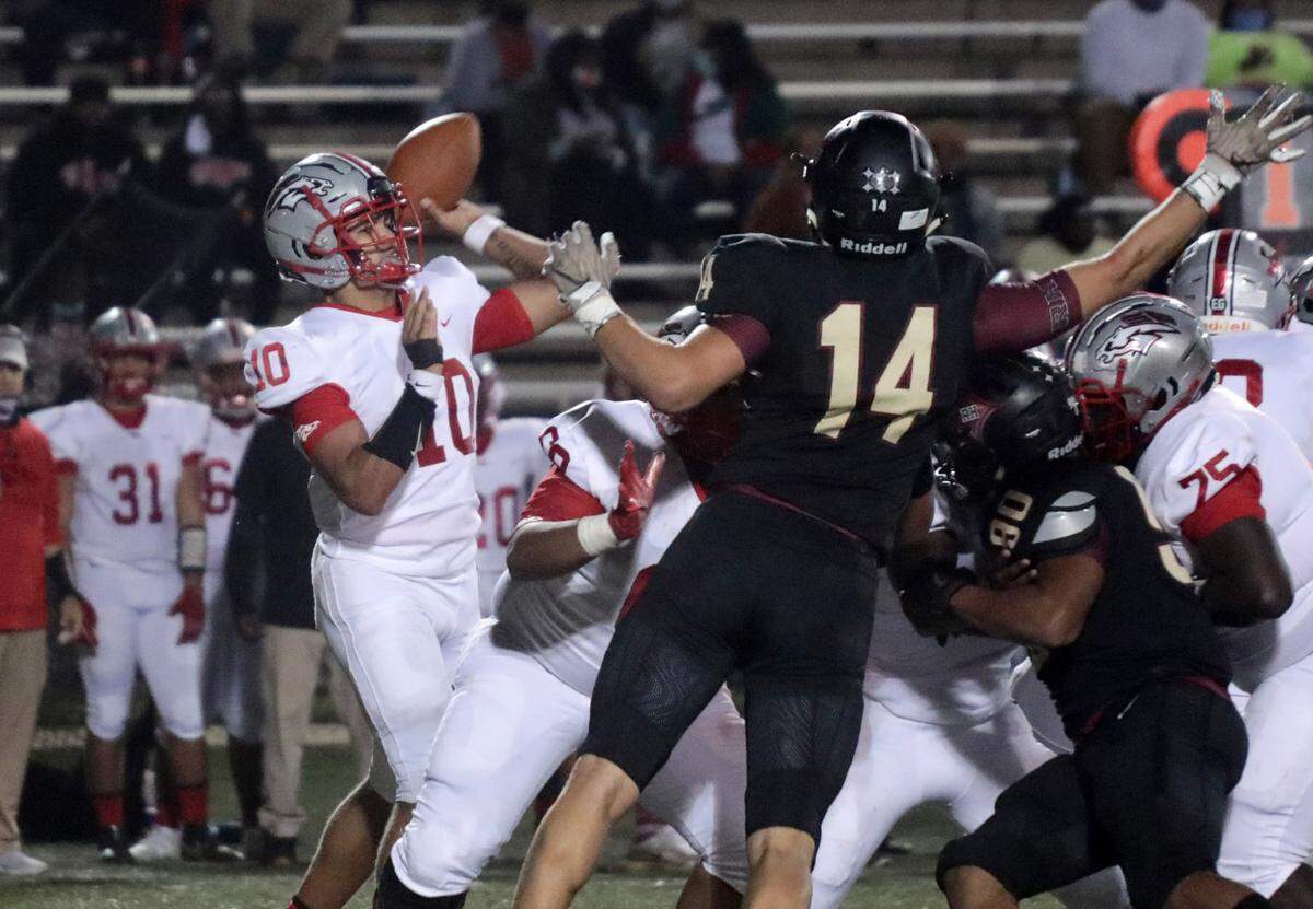 Herald file: Luke Bracey (14) rushes the passer in Rock Hill High’s 2020 season finale loss against South Pointe.