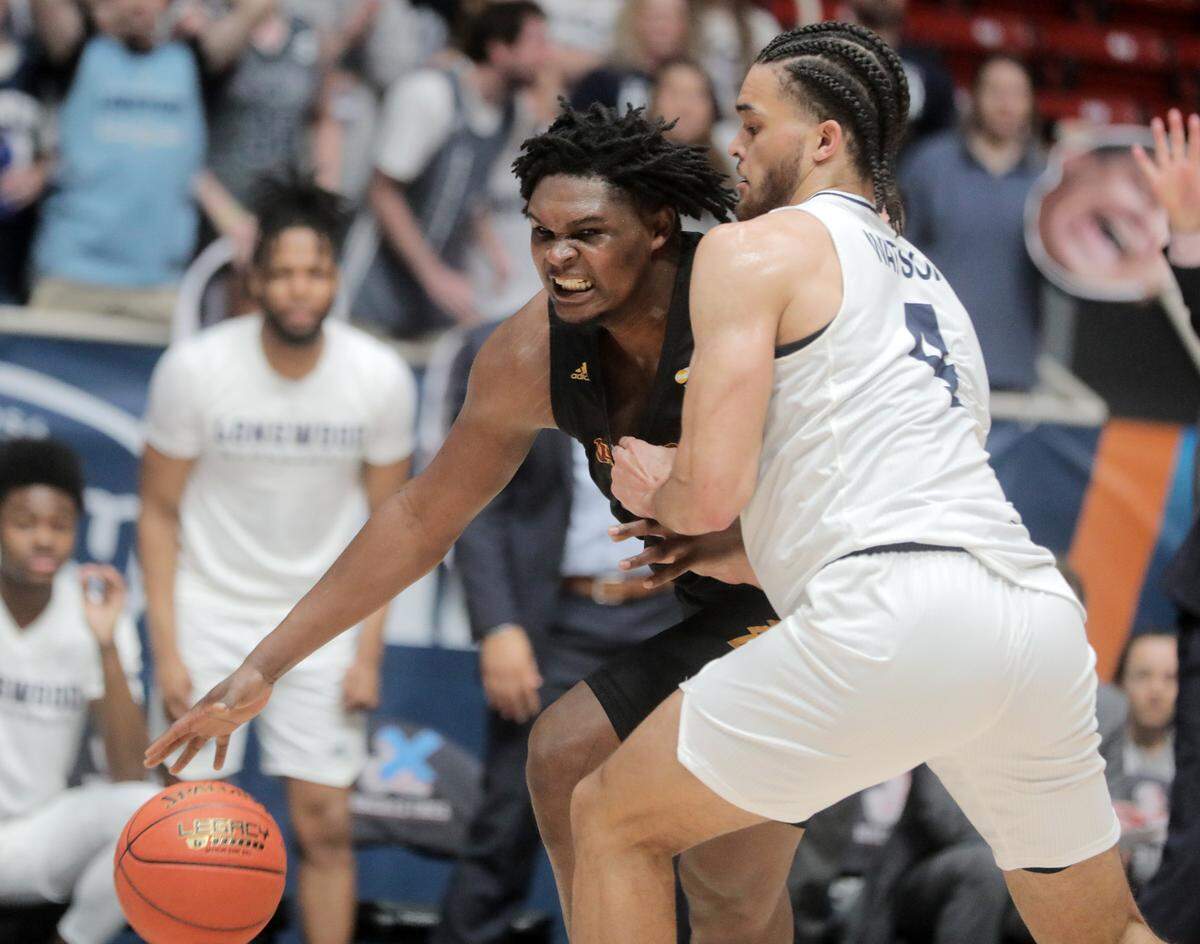 Winthrop’s D.J. Burns tries to get around Longwood’s Zac Watson Sunday at the Big South Championship game.