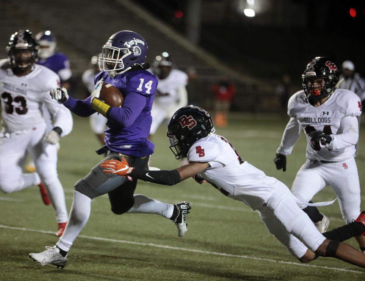 Northwestern’s Turbo Richard (14) flies by Boiling Springs’ Kairon Hines as the Trojans take on the Bulldogs in Rock Hill on Friday (Nov. 9, 2021). Northwestern hosts Byrnes in Round 2 of the high school football state playoffs.