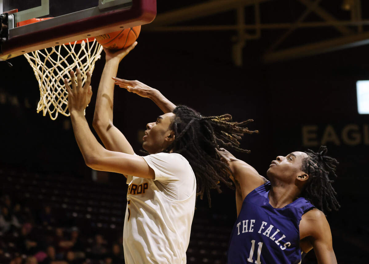 Winthrop’s Yoro Diallo, left, takes the ball to the basket against Toccoa Falls’ Ramod Godfrey.