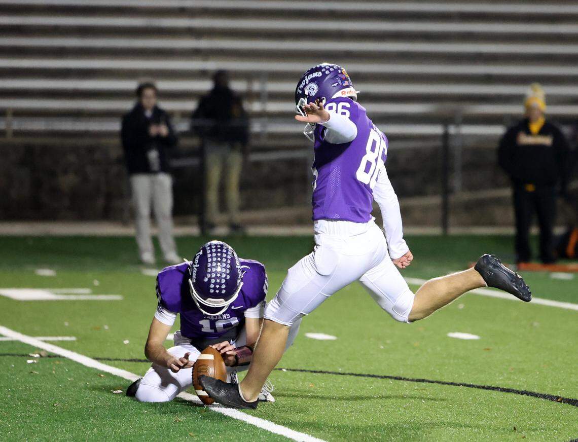 Northwestern quarterback Finley Polk holds the ball for kicker Matthew Fish Friday in Rock Hill, S.C.