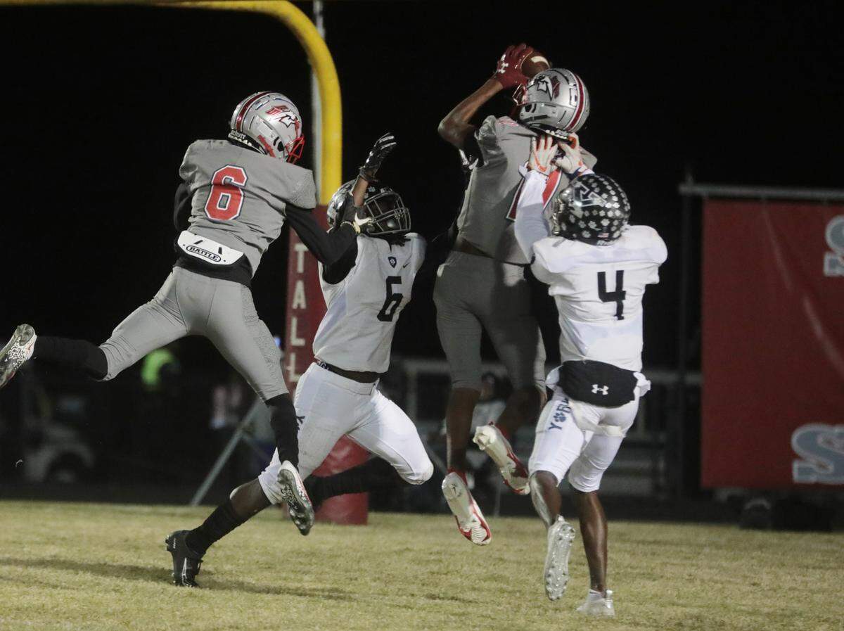 York Comprehensive’s R.J. Glasgow (6) and Zy Brown (4) put pressure on South Pointe’s Armendiz Huskey (11) as South Pointe’s Quan Peterson (6) follows.