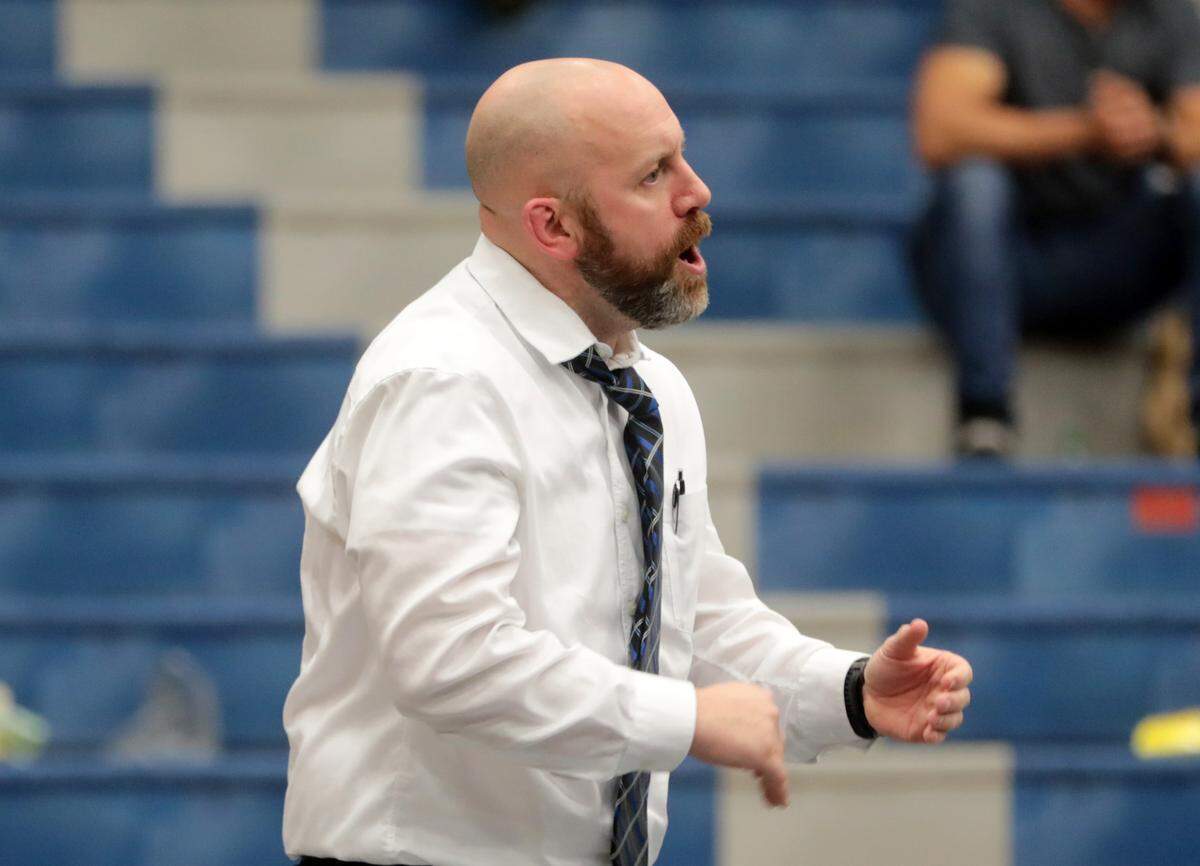 Clover High School wrestling coach Mike Fitzgerald talks to a wrestler.