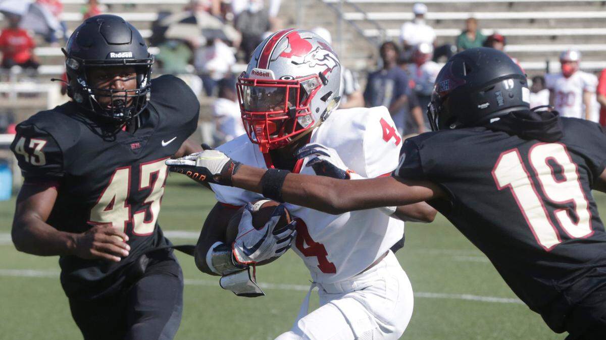 Rock Hill’s Aj Cooper (19) and TaRacqus Young Jr. (43) try to stop South Pointe’s Carl Mann III.