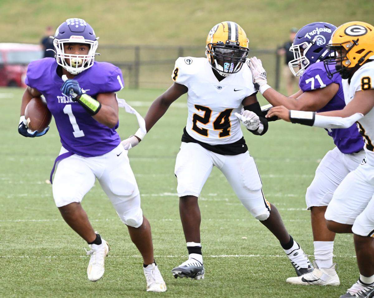 Northwestern’s Turbo Richard (1) is followed by Greenwood’s Damarion Roman (24) and Josiah Jeffery (8) while Northwestern’s Marcus Macon (71) tries to hold off Roman Saturday.