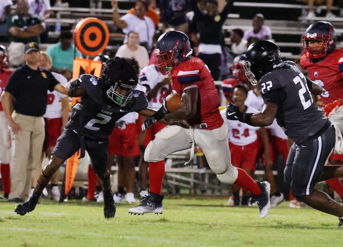 Chester’s Hudhaifah Taylor tries to run past York’s Jaden Sanders (2) and Kyreek Love (22) Friday at a scrimmage in Union.