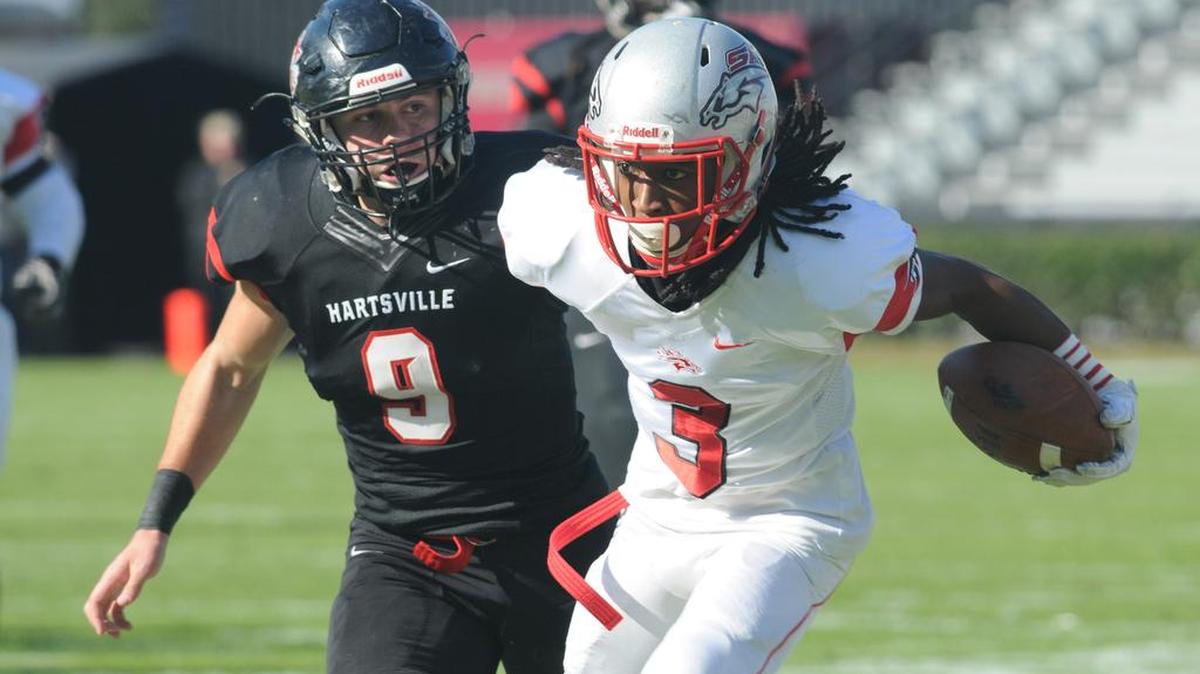 South Pointe’s Steven Gilmore Jr. carries the ball as Hartsville’s Logan Carpenter follows during the Stallions’ 4A state championship win Saturday in Columbia.