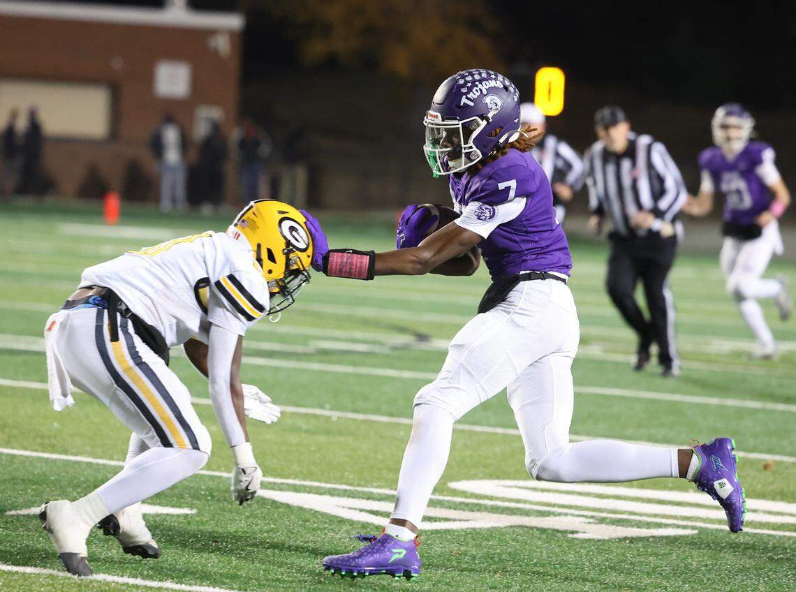 Northwestern’s Tadarrian Knox (7) is met with Greenwood’s Khamari Griffin (0) Friday in Rock Hill.