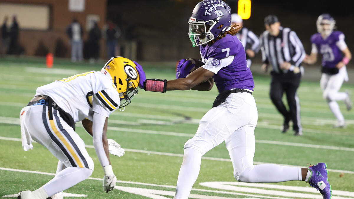 Northwestern’s Tadarrian Knox (7) is met with Greenwood’s Khamari Griffin (0) Friday in Rock Hill.