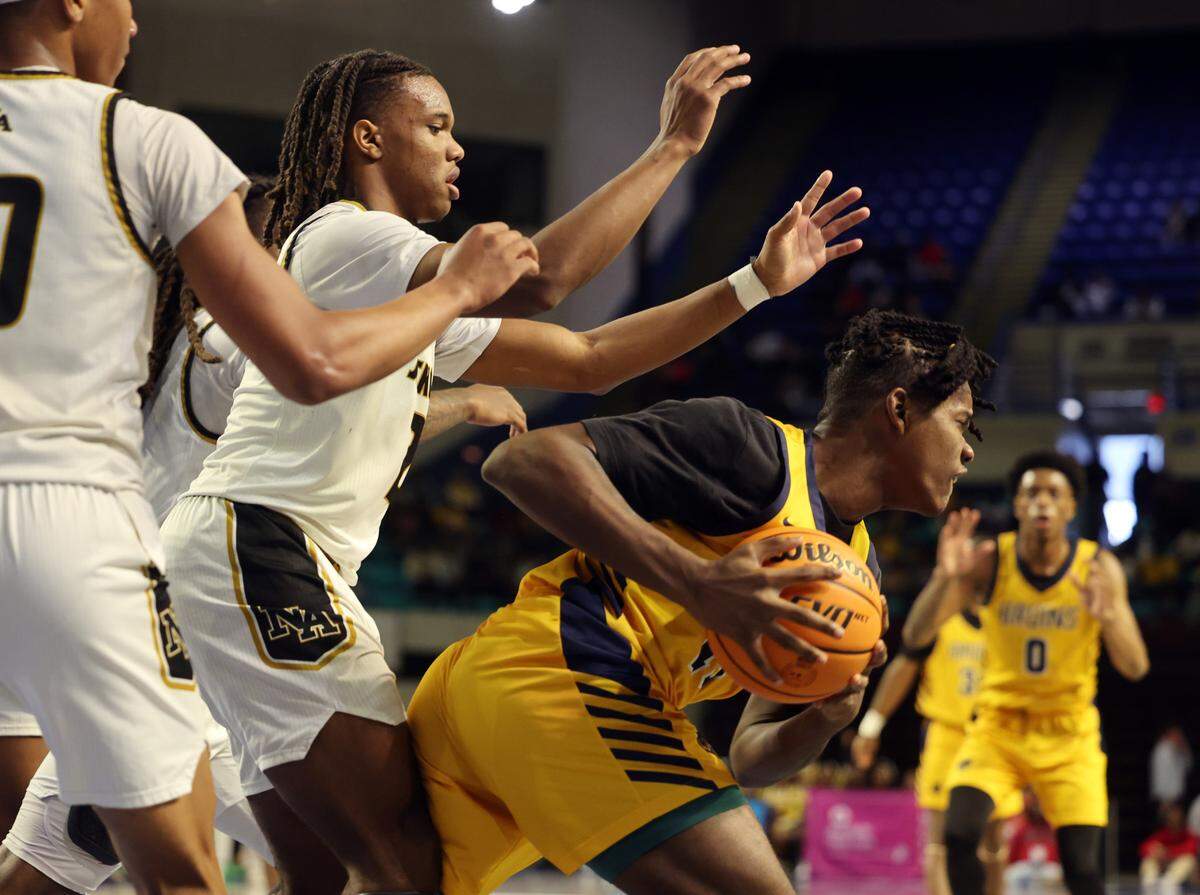 Lancaster’s Niquan White struggles to keep the ball against North Augusta’s Toian Nabriat Friday at the Class 4A state championships in Florence